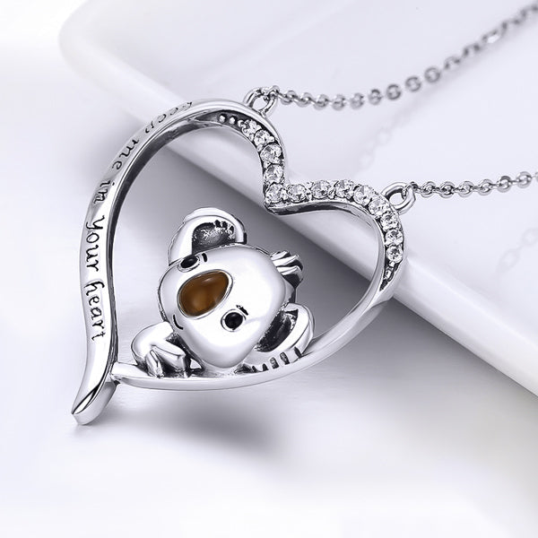 Silver koala and heart necklace display