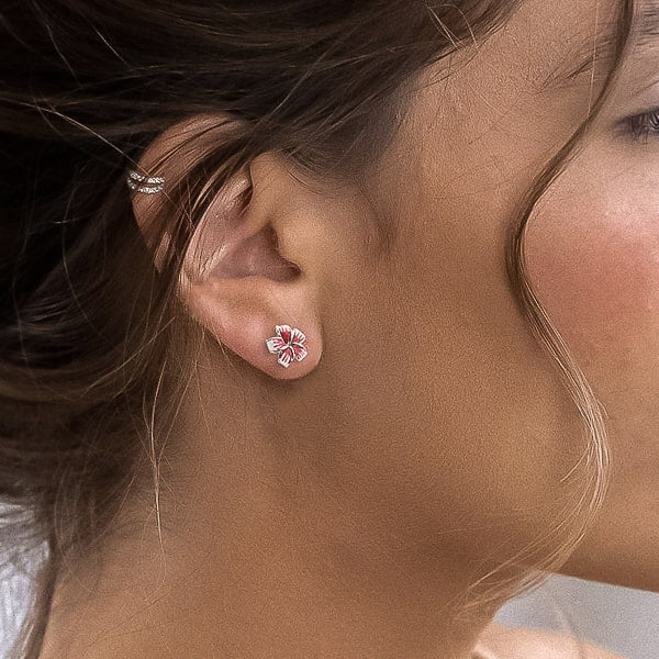 Woman wearing silver lily flower stud earrings