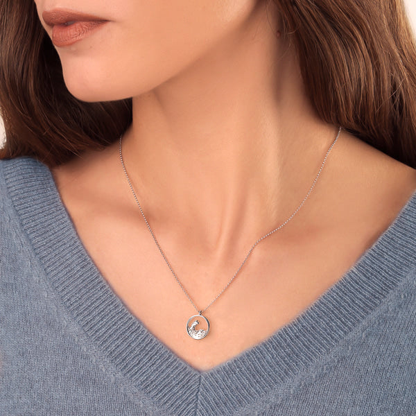 Woman wearing a silver ocean wave necklace