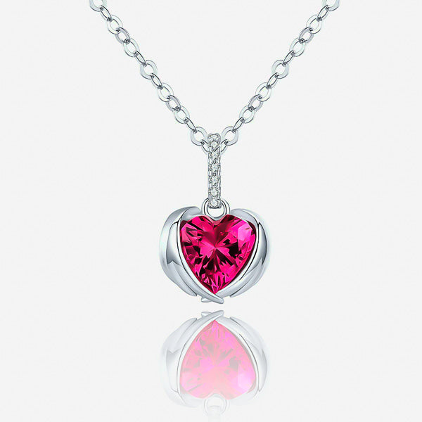 Details of the fuchsia pink crystal heart pendant with protective wings on a silver necklace