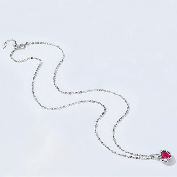 Full display of the fuchsia pink crystal heart pendant with protective wings on a silver necklace 