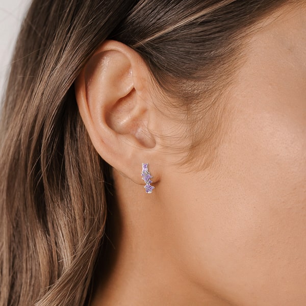 Woman wearing silver purple crystal U hoop earrings
