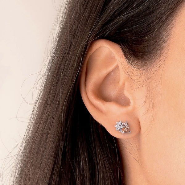 Woman wearing silver champagne floral crystal cluster stud earrings