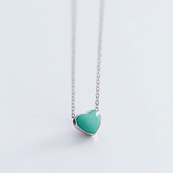 Small green heart on a silver necklace display