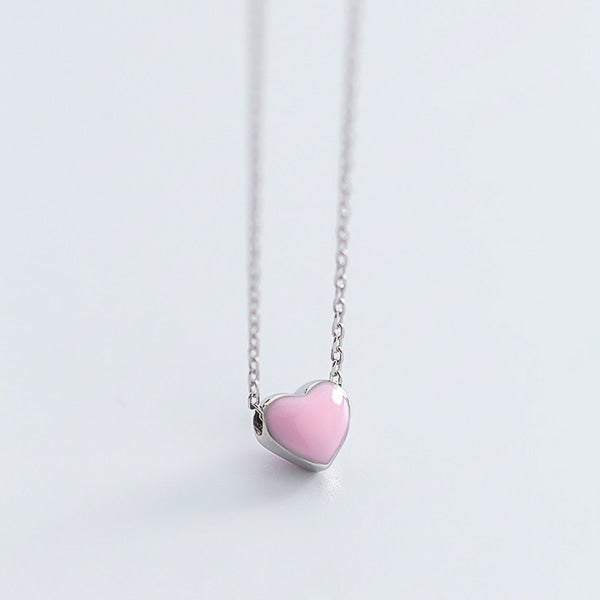 Small pink heart on a silver necklace display
