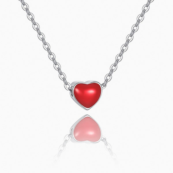 Small red heart on a silver necklace details