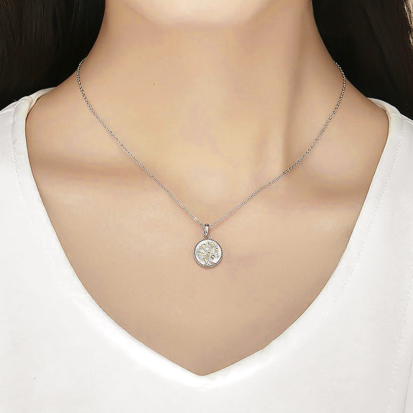 Woman wearing a silver tree of life coin pendant necklace