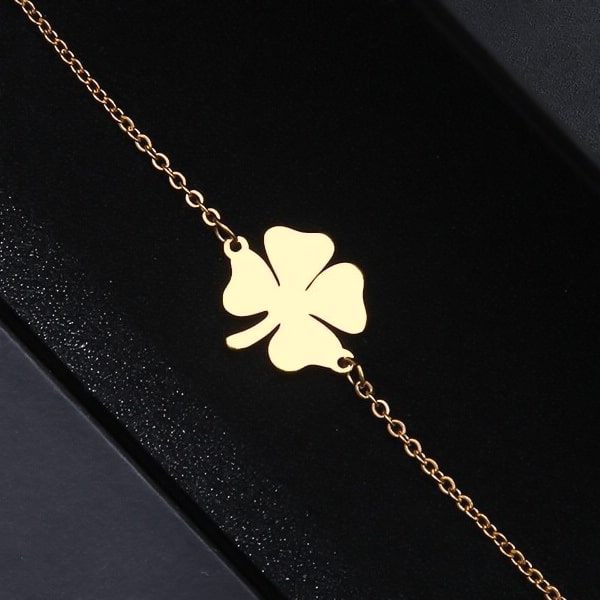 Simple gold lucky bracelet with a four-leaf clover charm