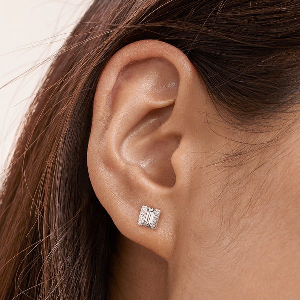 Woman wearing square mixed cut cubic zirconia stud earrings