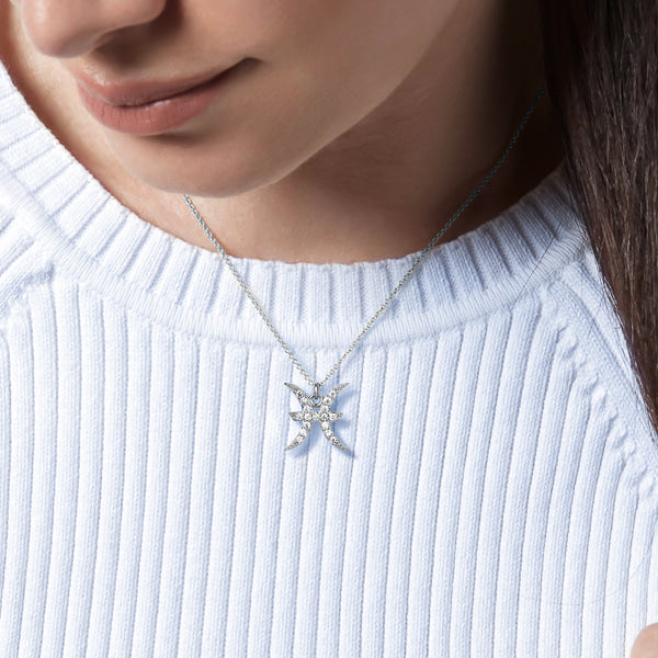 Woman wearing a sterling silver Pisces necklace