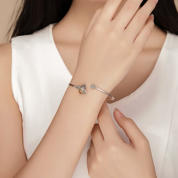 Sterling silver bee cuff bracelet on a woman's wrist