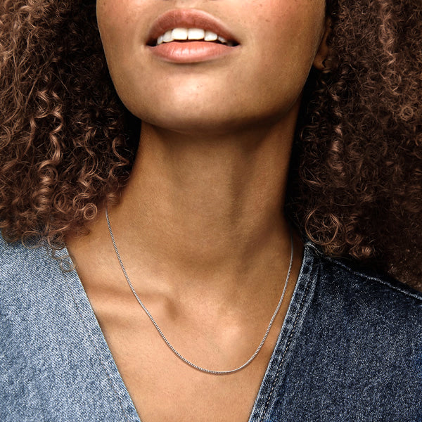 Woman wearing sterling silver curb chain necklace