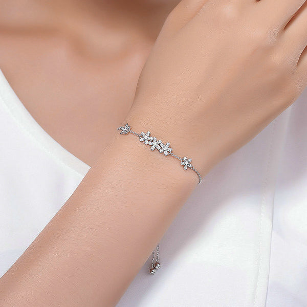 Sterling silver designer flower bracelet on a woman's wrist