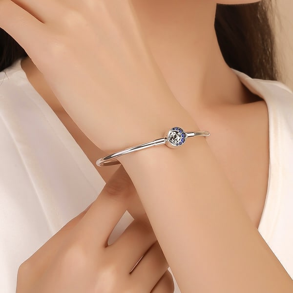 Sterling silver moon & stars bangle bracelet on a woman's wrist
