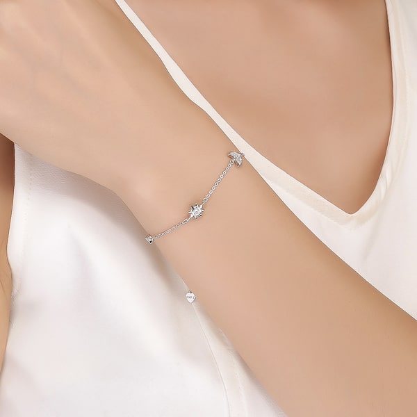 Sterling silver moon & sun bracelet on a woman's wrist