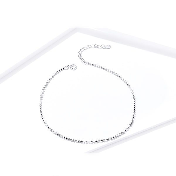 Sterling silver simple beaded ankle bracelet on a white background