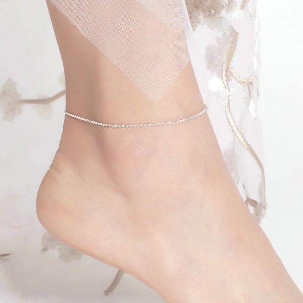 Silver simple beaded anklet on a womans ankle