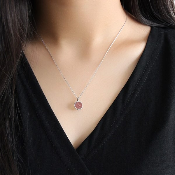 Woman wearing a strawberry quartz pendant necklace