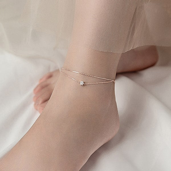 Woman wearing a delicate rose gold crystal anklet
