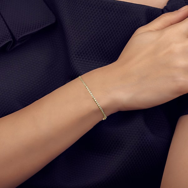 10K gold vermeil crystal cable chain bracelet on a woman's wrist