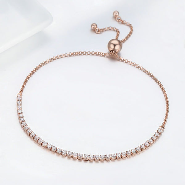 Rose gold tennis bracelet with an adjustable bolo closure close up
