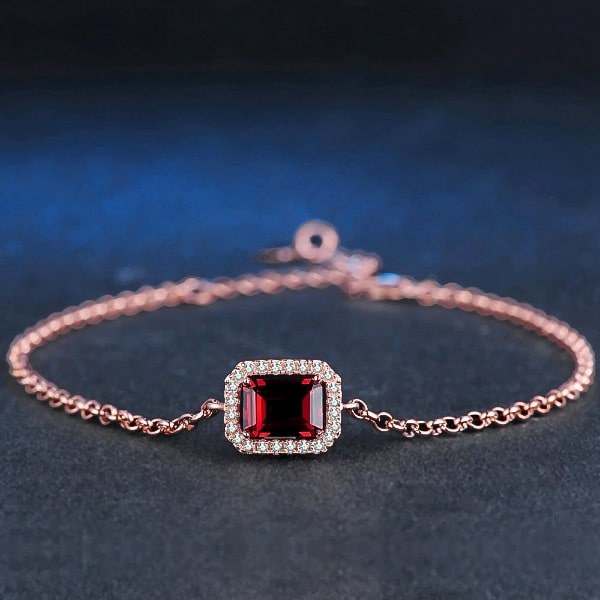 Rose gold vermeil bracelet with red emerald cut garnet close up