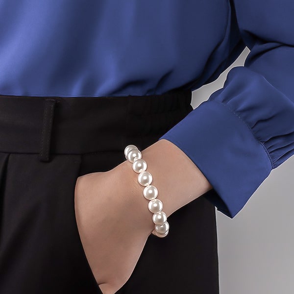 12mm pearl bracelet on a woman's wrist