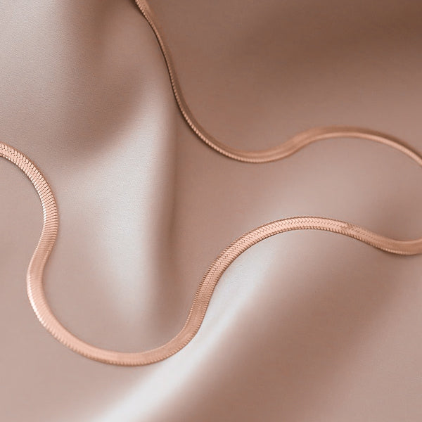 Detail photo of a waterproof 2mm rose gold herringbone chain necklace
