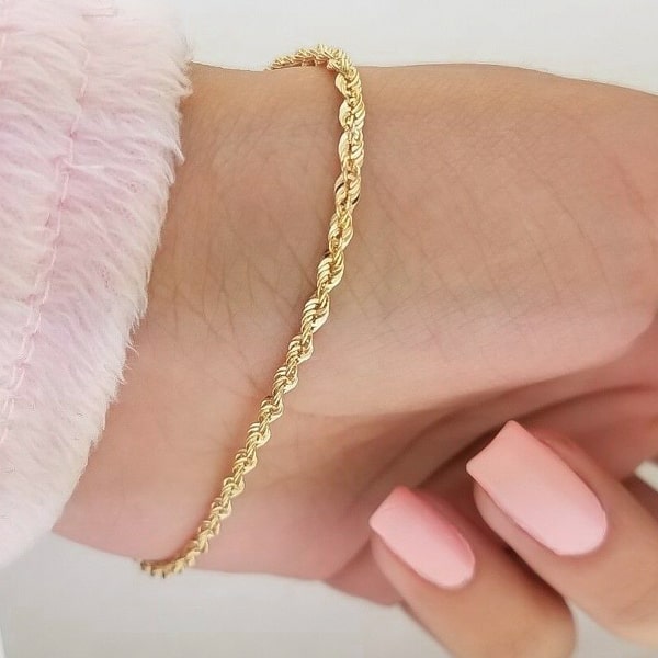 2mm gold rope chain bracelet displayed on a womans wrist