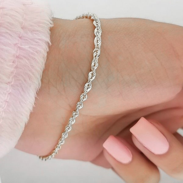 2mm silver rope chain bracelet displayed on a woman's wrist