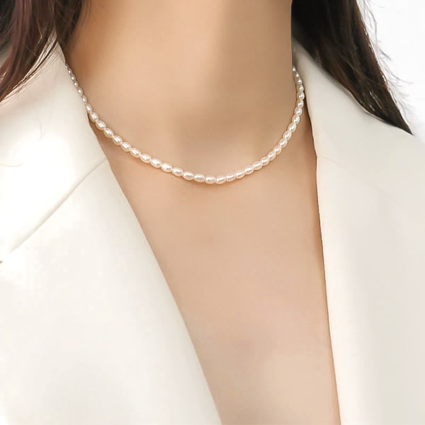 Woman wearing a 3-4mm oval freshwater pearl necklace