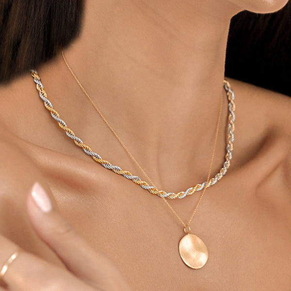 Woman wearing a 3mm two-tone gold and silver rope chain necklace