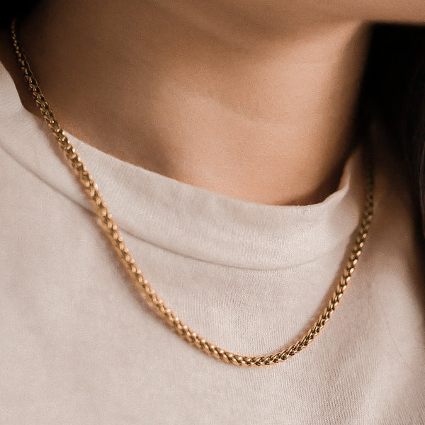 Woman wearing a 3mm gold wheat chain necklace