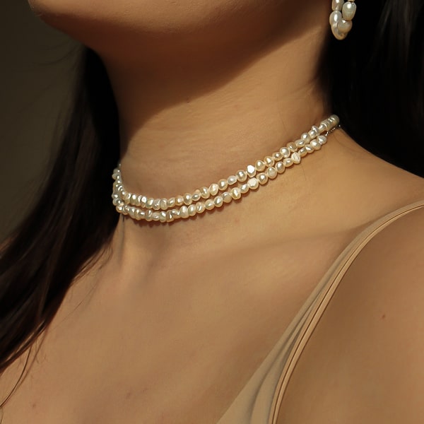 two 4-5mm baroque freshwater pearl choker necklaces on a woman's neck