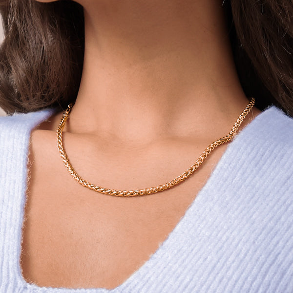 Woman wearing a 4mm gold wheat chain necklace