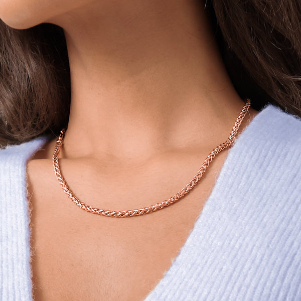 Woman wearing a 4mm rose gold wheat chain necklace