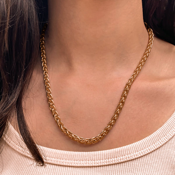 Woman wearing a 6mm gold wheat chain necklace