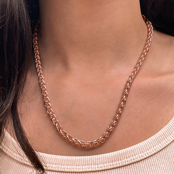 Woman wearing a 6mm rose gold wheat chain necklace