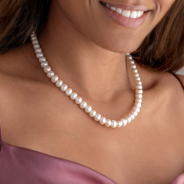 Freshwater pearl necklace with 9-10mm oval pearls on woman's neck