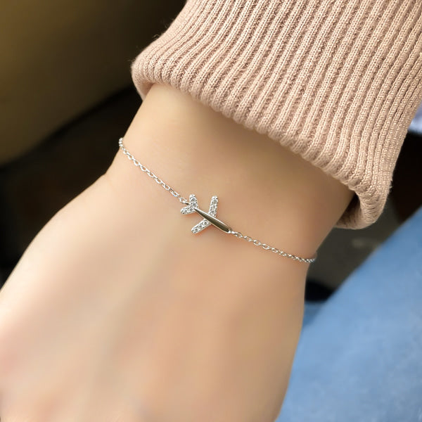 Sterling silver airplane bracelet on a woman's wrist