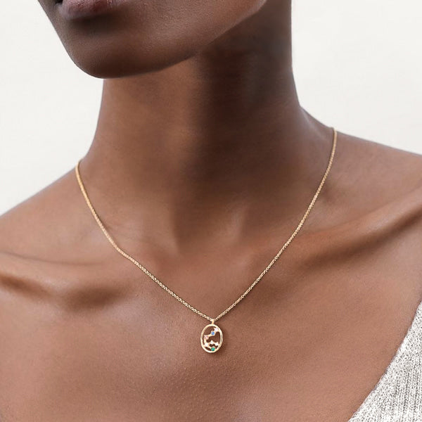 Woman wearing an Aquarius constellation necklace