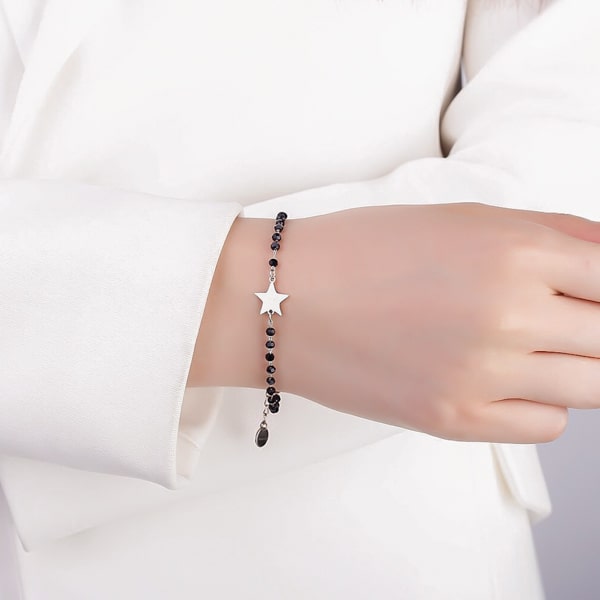 Woman wearing a black and silver beaded star bracelet