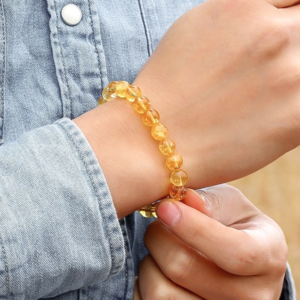 Beaded citrine crystal quartz bracelet on a woman's wrist