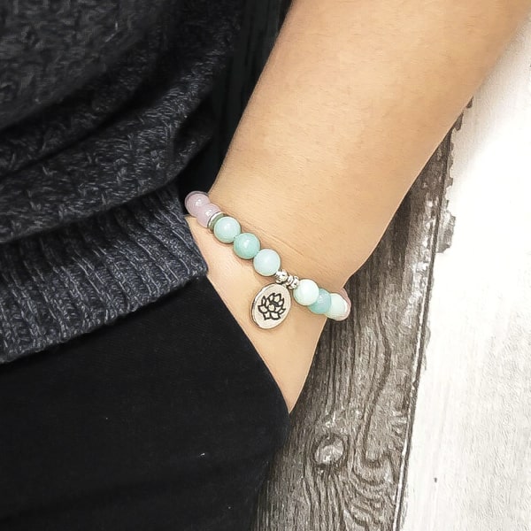 Beaded lotus flower charm bracelet on a woman's wrist