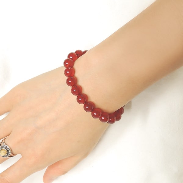 Beaded red agate bracelet on a woman's wrist