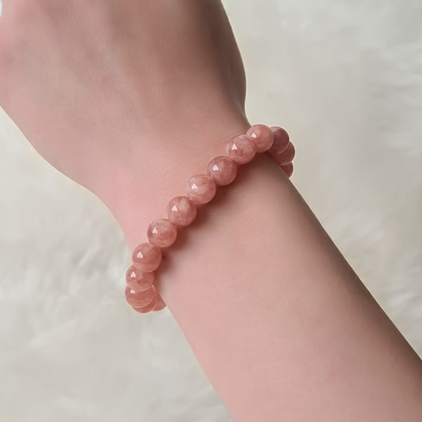 Beaded rose quartz bracelet on a woman's wrist