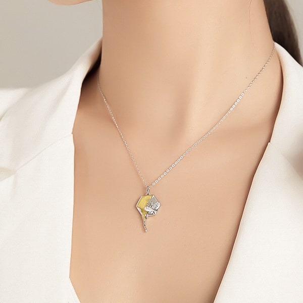 Woman wearing a honeycomb and bee pendant necklace made of 925 sterling silver