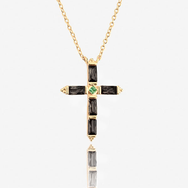 Black crystal cross on a gold necklace details