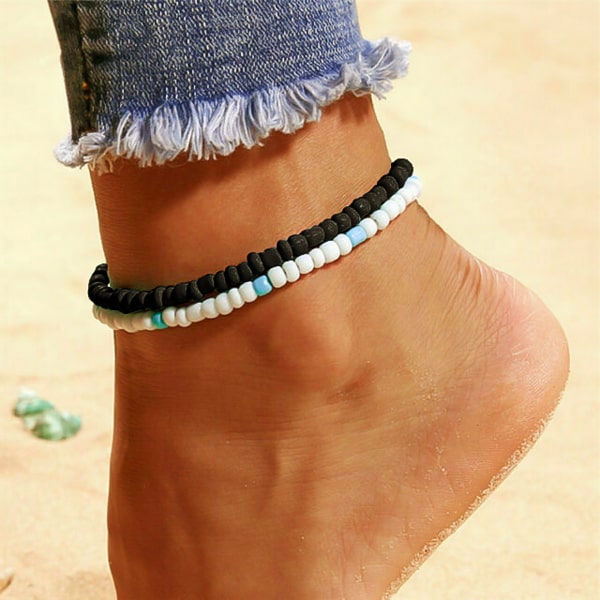 Black handmade beaded anklet on a womans ankle