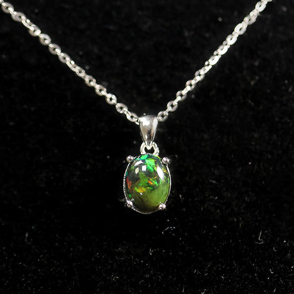 Black opal necklace on a dark background